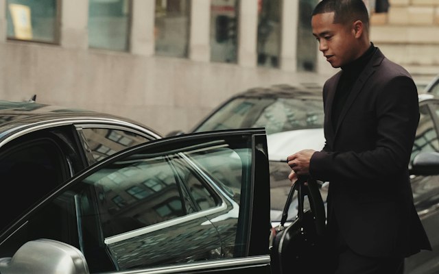 Chauffeur opening a car door